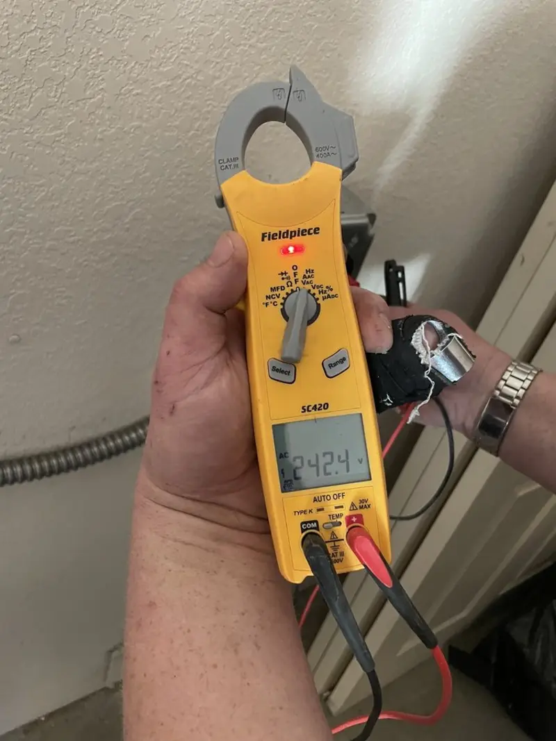 Voltage testing with clamp meter during Outlet Installation in Columbus